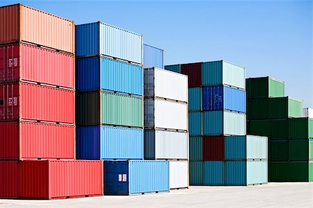 sascha (artist) - cargo shipping containers stacked at harbor freight terminal under clear blue sky Fotografie stock - Microstock e Abbonamento, Codice: 400-04042455