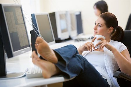 Woman in computer room with feet up drinking coffee Stock Photo - Budget Royalty-Free & Subscription, Code: 400-04042734