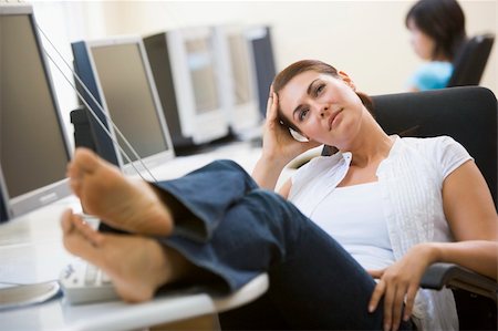 Woman in computer room with feet up thinking Stock Photo - Budget Royalty-Free & Subscription, Code: 400-04042733