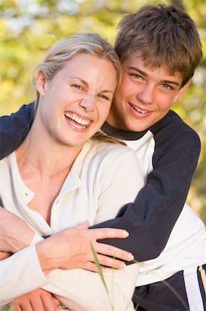 simsearch:400-04042848,k - Woman and young boy embracing outdoors and smiling Fotografie stock - Microstock e Abbonamento, Codice: 400-04042766