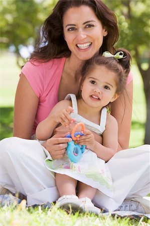 simsearch:400-04043055,k - Woman and young girl sitting outdoors with toy smiling Stock Photo - Budget Royalty-Free & Subscription, Code: 400-04042789