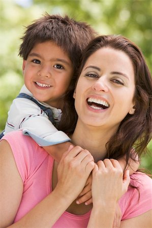 simsearch:400-04042848,k - Woman and young boy embracing outdoors smiling Fotografie stock - Microstock e Abbonamento, Codice: 400-04042792