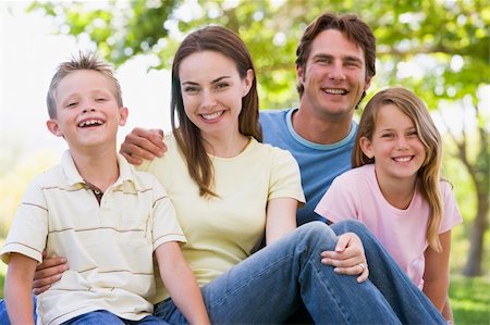 simsearch:400-04043055,k - Family sitting outdoors smiling Stock Photo - Budget Royalty-Free & Subscription, Code: 400-04042808