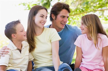 simsearch:400-05736759,k - Family sitting outdoors smiling Stock Photo - Budget Royalty-Free & Subscription, Code: 400-04042809