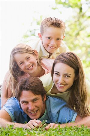 simsearch:400-04042848,k - Family lying outdoors smiling Fotografie stock - Microstock e Abbonamento, Codice: 400-04042816