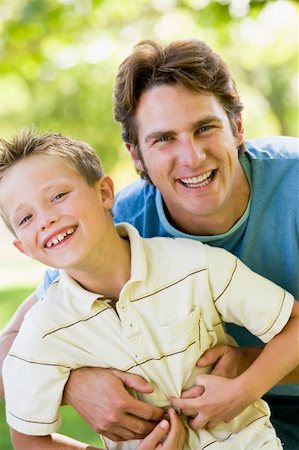 simsearch:400-04042848,k - Man and young boy outdoors embracing and smiling Fotografie stock - Microstock e Abbonamento, Codice: 400-04042824