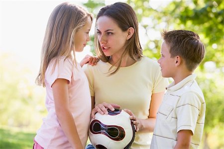 Woman and two young children outdoors holding volleyball and smi Stock Photo - Budget Royalty-Free & Subscription, Code: 400-04042822