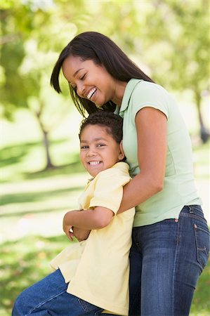 simsearch:400-04042848,k - Woman and young boy outdoors embracing and smiling Fotografie stock - Microstock e Abbonamento, Codice: 400-04042838