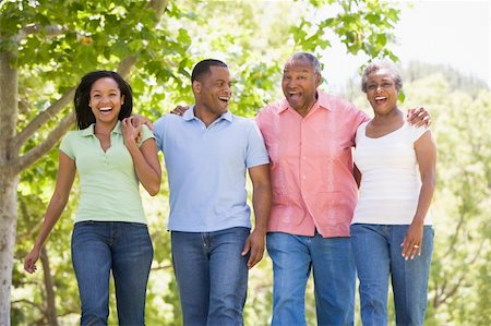 simsearch:649-07239718,k - Two couples walking outdoors arm in arm smiling Stock Photo - Budget Royalty-Free & Subscription, Code: 400-04042844