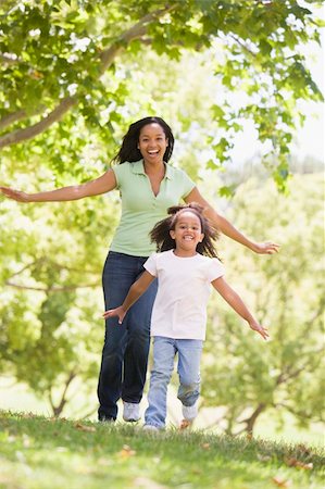 simsearch:400-04043055,k - Woman and young girl running outdoors smiling Stock Photo - Budget Royalty-Free & Subscription, Code: 400-04042841