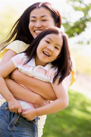 simsearch:400-04043055,k - Woman and young girl outdoors embracing and smiling Stock Photo - Budget Royalty-Free & Subscription, Code: 400-04042857