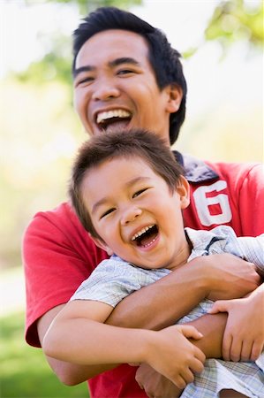 simsearch:400-04042848,k - Man and young boy outdoors embracing and smiling Fotografie stock - Microstock e Abbonamento, Codice: 400-04042858