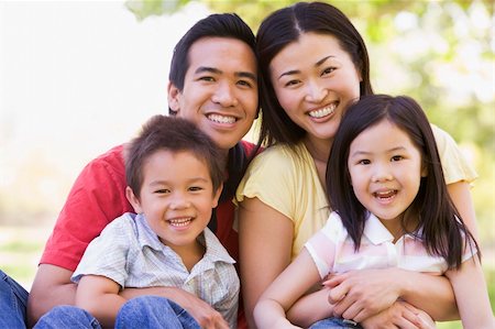 simsearch:400-04043055,k - Family sitting outdoors smiling Stock Photo - Budget Royalty-Free & Subscription, Code: 400-04042860