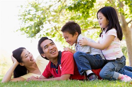 simsearch:400-04046012,k - Family lying outdoors being playful and smiling Stockbilder - Microstock & Abonnement, Bildnummer: 400-04042861