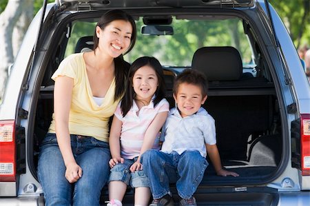 Woman with two children sitting in back of van smiling Stock Photo - Budget Royalty-Free & Subscription, Code: 400-04042873