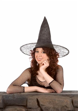 simsearch:400-04007612,k - Portrait of Latina teenager girl in black Halloween hat and fishnet dress by stone fence Stock Photo - Budget Royalty-Free & Subscription, Code: 400-04042965