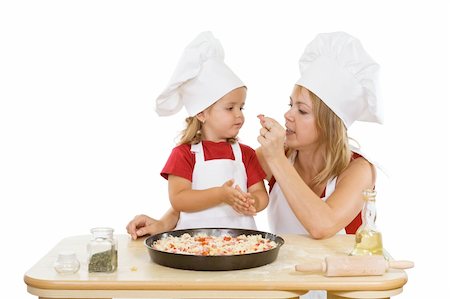 family cheese - Woman and little girl preparing a pizza - tasting ingredients - isolated Stock Photo - Budget Royalty-Free & Subscription, Code: 400-04043015