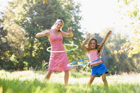 simsearch:400-04043055,k - Woman and young girl outdoors using hula hoops and smiling Stock Photo - Budget Royalty-Free & Subscription, Code: 400-04043045