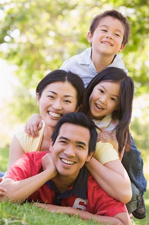 simsearch:400-04043055,k - Family lying outdoors smiling Stock Photo - Budget Royalty-Free & Subscription, Code: 400-04043056