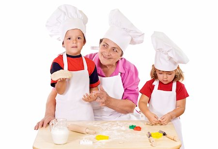 Kids with grandmother preparing cookies - isolated Stock Photo - Budget Royalty-Free & Subscription, Code: 400-04043260