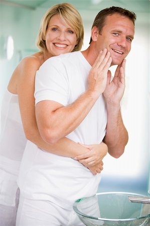 Couple in bathroom embracing and smiling Stock Photo - Budget Royalty-Free & Subscription, Code: 400-04043408
