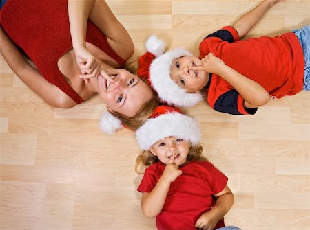 Woman and kids on the floor waiting for christmas and Santa Stock Photo - Budget Royalty-Free & Subscription, Code: 400-04043705