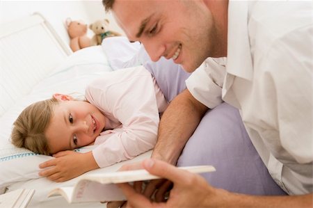 Man reading book to young girl in bed smiling Stock Photo - Budget Royalty-Free & Subscription, Code: 400-04043780