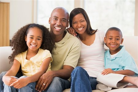 Family sitting in living room smiling Stock Photo - Budget Royalty-Free & Subscription, Code: 400-04043796