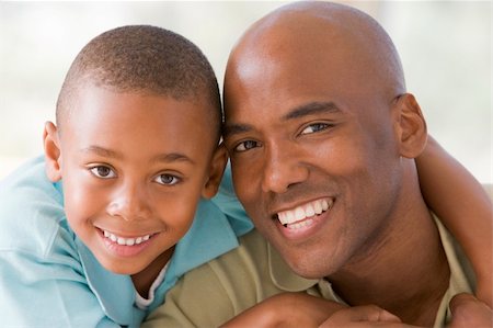 Man and young boy embracing and smiling Stock Photo - Budget Royalty-Free & Subscription, Code: 400-04043797