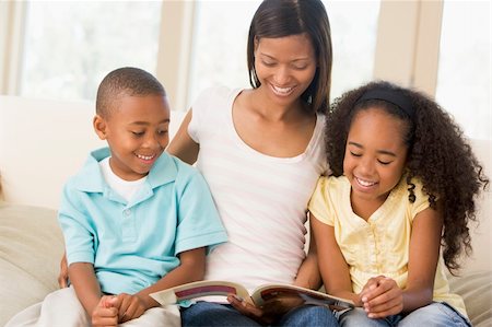 Woman and two children sitting in living room reading book and s Stock Photo - Budget Royalty-Free & Subscription, Code: 400-04043801