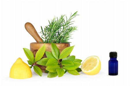 Herb leaf selection of rosemary, bay leaves and two lemon halves, with an olive wood pestle and mortar and an aromatherapy essential oil blue glass bottle. Over white background. Stock Photo - Budget Royalty-Free & Subscription, Code: 400-04043853