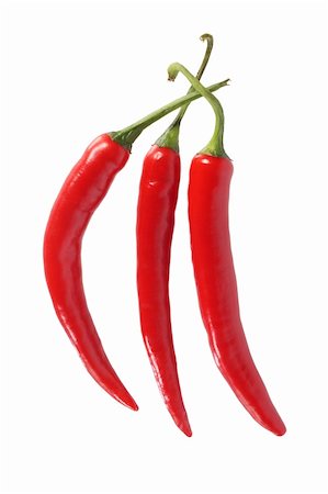 Three hot red chili peppers, isolated on white background Stock Photo - Budget Royalty-Free & Subscription, Code: 400-04043934