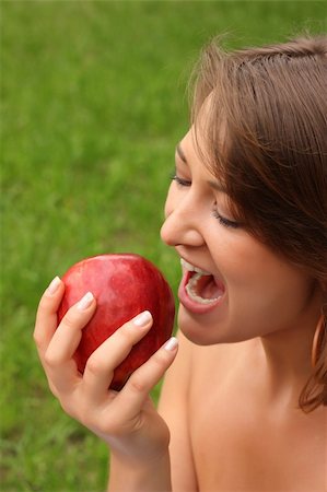 Girl going to bite red delicious apple Stock Photo - Budget Royalty-Free & Subscription, Code: 400-04043941