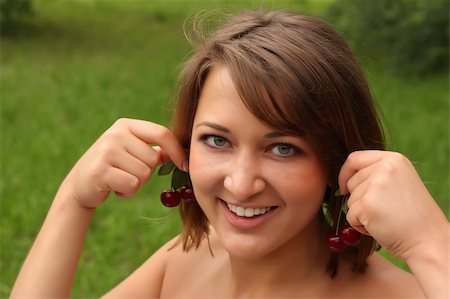 Girl holding cherries like earrings Stock Photo - Budget Royalty-Free & Subscription, Code: 400-04043942