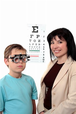 An eye doctor stands with a patient who is wearing trial frames during examination. Stockbilder - Microstock & Abonnement, Bildnummer: 400-04043943