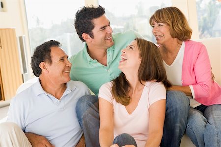 simsearch:400-05736759,k - Two couples sitting in living room smiling and laughing Stock Photo - Budget Royalty-Free & Subscription, Code: 400-04043983