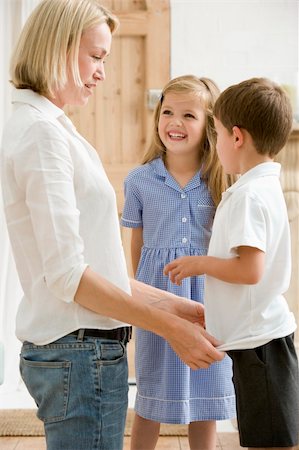 simsearch:877-06835784,k - Woman in front hallway with two young children smiling Stock Photo - Budget Royalty-Free & Subscription, Code: 400-04043995