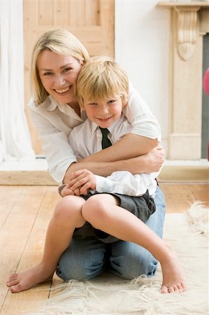 Woman in front hallway hugging young boy and smiling Stock Photo - Budget Royalty-Free & Subscription, Code: 400-04043998