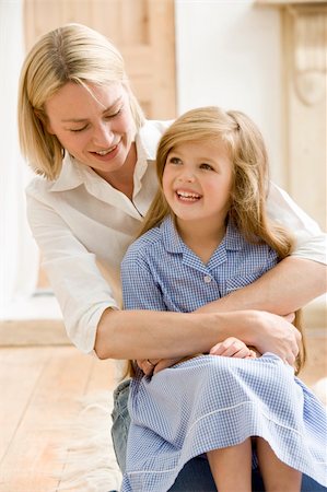 Woman in front hallway hugging young girl and smiling Stock Photo - Budget Royalty-Free & Subscription, Code: 400-04043993