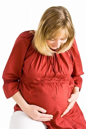 simsearch:400-04859723,k - A pregnant lady looking down at her stomach Fotografie stock - Microstock e Abbonamento, Codice: 400-04054291