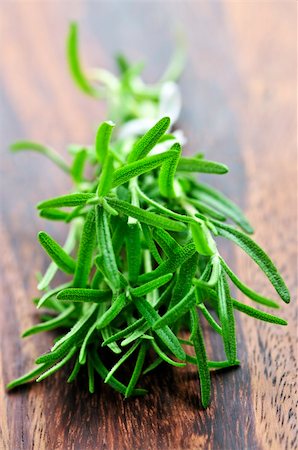 rosemary sprig - Bunch of fresh herb rosemary close up on wooden cutting board Stock Photo - Budget Royalty-Free & Subscription, Code: 400-04054927