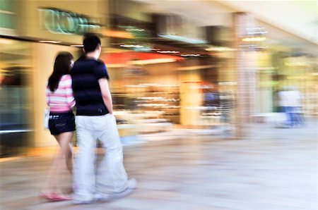 Couple shopping in a mall, panning shot, intentional in-camera motion blur Foto de stock - Super Valor sin royalties y Suscripción, Código: 400-04054950