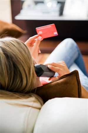 simsearch:614-01433346,k - Young woman relaxing at home on the phone with credit card Foto de stock - Royalty-Free Super Valor e Assinatura, Número: 400-04055338