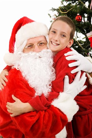 simsearch:400-05008640,k - Cute little boy giving Santa Claus a big hug on Christmas morning. Photographie de stock - Aubaine LD & Abonnement, Code: 400-04056235