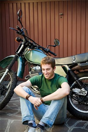 Portrait of young man leaning on motorbike Stock Photo - Budget Royalty-Free & Subscription, Code: 400-04056501