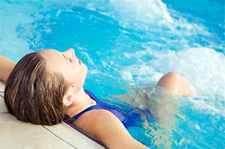 Portrait of young woman sitting in swimming pool Stock Photo - Budget Royalty-Free & Subscription, Code: 400-04056520