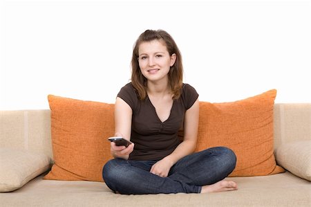 simsearch:400-04540885,k - casual woman sitting on sofa with remote control Foto de stock - Royalty-Free Super Valor e Assinatura, Número: 400-04056754