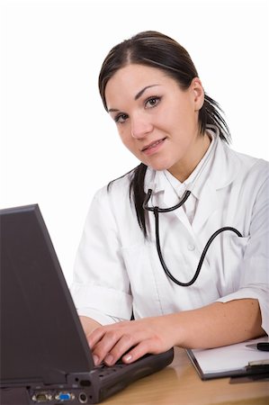 doctor business computer - attractive brunette woman at desk. over white background Stock Photo - Budget Royalty-Free & Subscription, Code: 400-04056761
