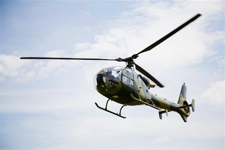 simsearch:400-05888607,k - Flying helicopter on blue sky Foto de stock - Royalty-Free Super Valor e Assinatura, Número: 400-04057214