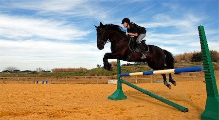 a young teenager and her black stallion in a training of jumping Foto de stock - Super Valor sin royalties y Suscripción, Código: 400-04057421